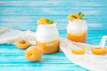 Natural yogurt in a jar with fresh apricots
