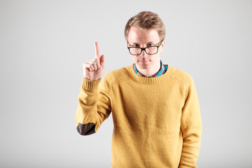 Man points forefinger up