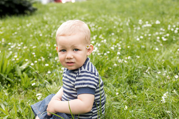 baby sitting on grass