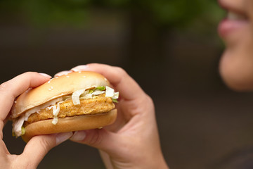 woman eating hamburger