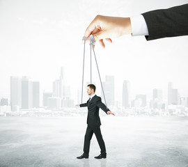 Businessman puppet on city background