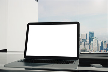 Blank laptop on city background