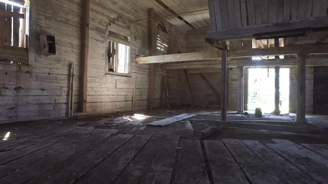 Old abandoned church or mill building. Steadicam shot. Smooth motion. Wooden building interior.