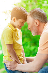 Cheerful old man and grandchild resting together