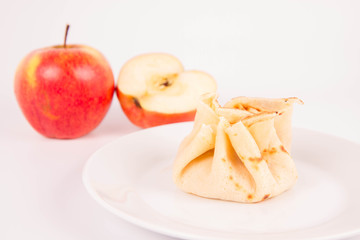 Pancake sack stuffed with braised apples decorated with apples