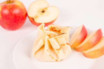 Pancake sack stuffed with braised apples decorated with apples