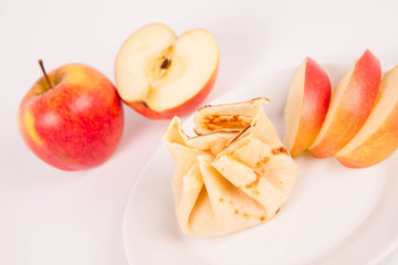 Naklejka na ściany i meble Pancake sack stuffed with braised apples decorated with apples