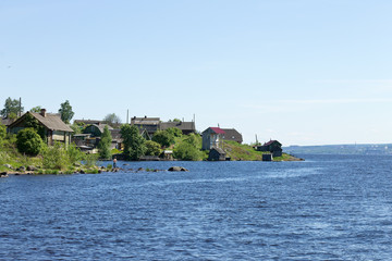 Rural landscape with wooden houses by the lake Onega in the Russian village