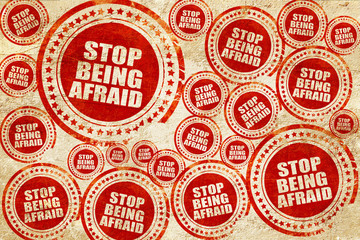 stop being afraid, red stamp on a grunge paper texture