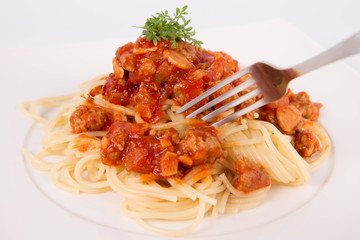 Spaghetti bolognese being eaten with a fork