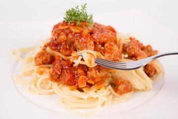 Spaghetti bolognese being eaten with a fork