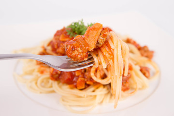 Spaghetti bolognese being eaten with a fork