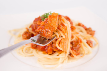 Spaghetti bolognese being eaten with a fork