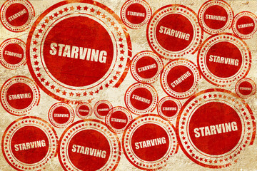 starving, red stamp on a grunge paper texture