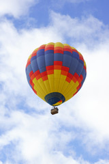 Balloon floats through spring clouds
