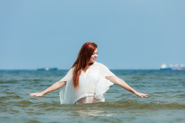 Fototapeta na wymiar Girl relaxing in sea water
