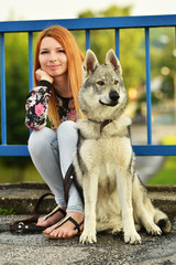 Lovely Woman Posing With a Wolf