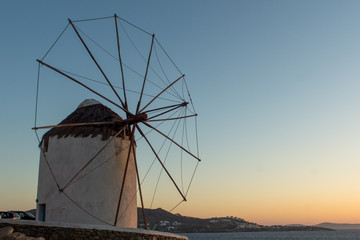 Amazing Sunset and White windmills on the island of Mykonos, Cyclades, Greece
