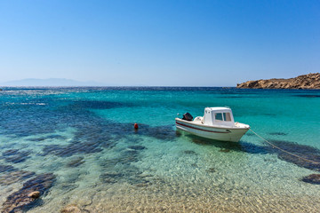 Small boat in Paranga Beach on the island of Mykonos, Cyclades, Greece