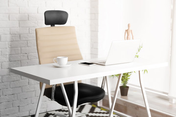 Modern workplace with office chair and laptop