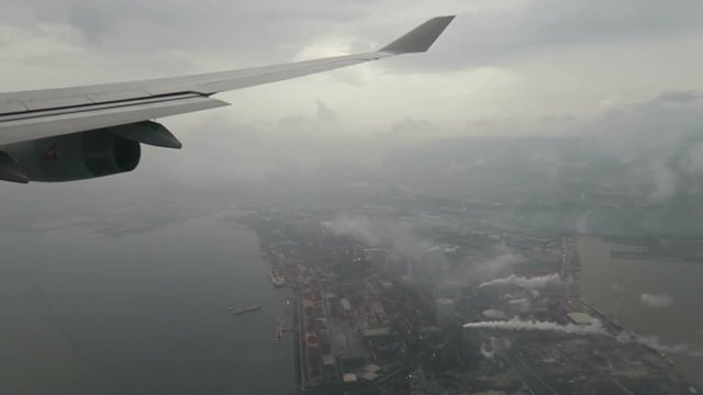 Aircraft Flying Over the City in the Rain