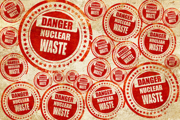 Nuclear danger background, red stamp on a grunge paper texture
