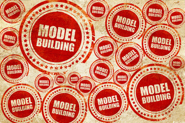 model building, red stamp on a grunge paper texture