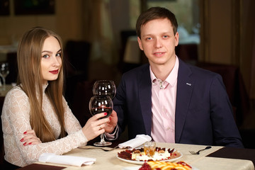 Couple toasting wineglasses in a luxury restaurant.