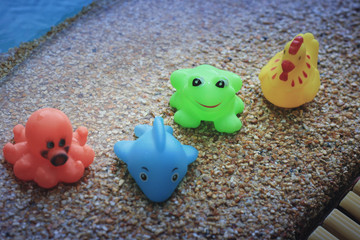 Colorful floating toys at swimming pool with selective focus