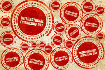 international friendship day, red stamp on a grunge paper textur