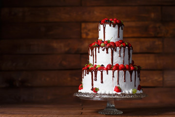 Strawberry cake on a wooden background.