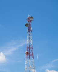 Communication tower antenna center on blue sky and clouds
