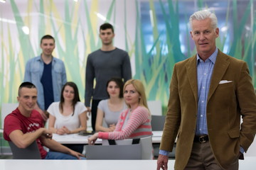 portrait of  teacher with students group in background