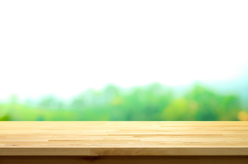 Wood table top on blur natural green background