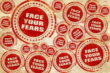 Fototapeta premium face your fears, red stamp on a grunge paper texture
