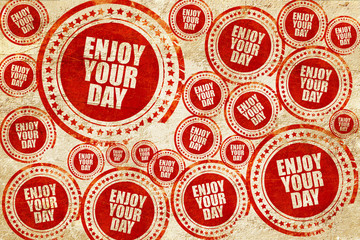 enjoy your day, red stamp on a grunge paper texture