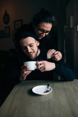 young man and woman posing indoors