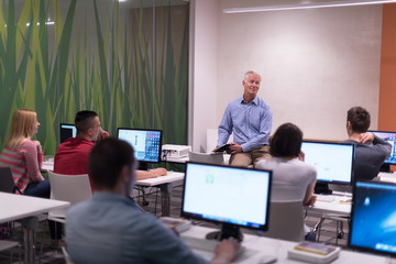 teacher and students in computer lab classroom