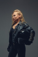 Fototapeta na wymiar Portrait of blond female in motorcycle uniform.