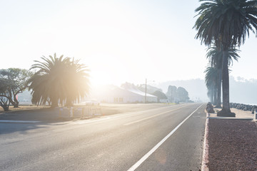 Fototapeta premium rural empty asphalt road near water at sunrise in san francisco