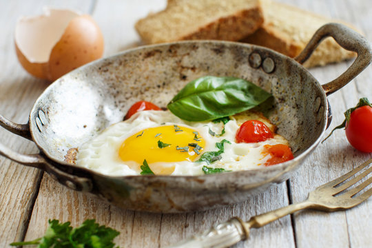 Fried egg on an old frying pan