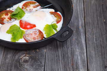 Homemade Omelette in a frypan. Eggs breakfast with tomato and pa