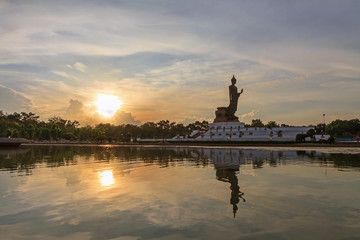 Big Buddha statue at the lake in sunset time
