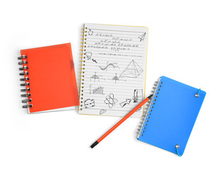 Desk with stationary and notebook with hand drawn doodles. Studi
