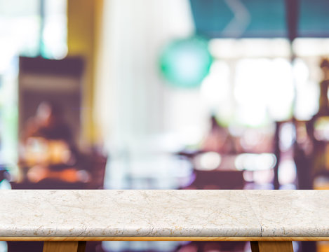 Empty white marble table and blurred cafe bokeh light background
