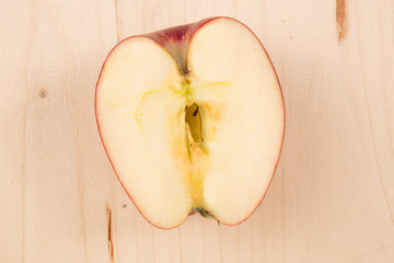 Flat lay of sliced fresh red apple on wooden background
