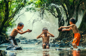 Childs splashing in the river - Powered by Adobe