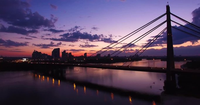 Aerial view of Road bridge - Moscow Bridge over Dnieper river in Kiev, Ukraine. Sunset in Kyiv, Eastern Europe