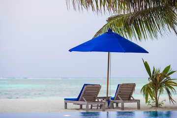 Sunbeds and umbrella at beautiful tropical resort
