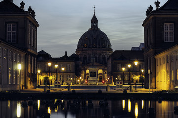 Frederik's Church also known as Marble Church and the equestrian statue at night with beautiful reflection in fountain in Copenhagen, Denmark.